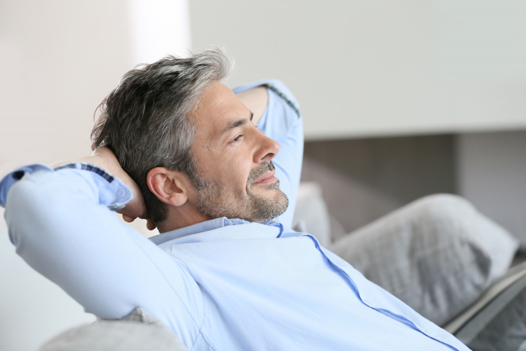 middle aged man resting in the sofa