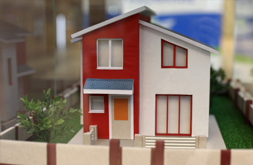simple modern home in a miniature diorama with grass and tree