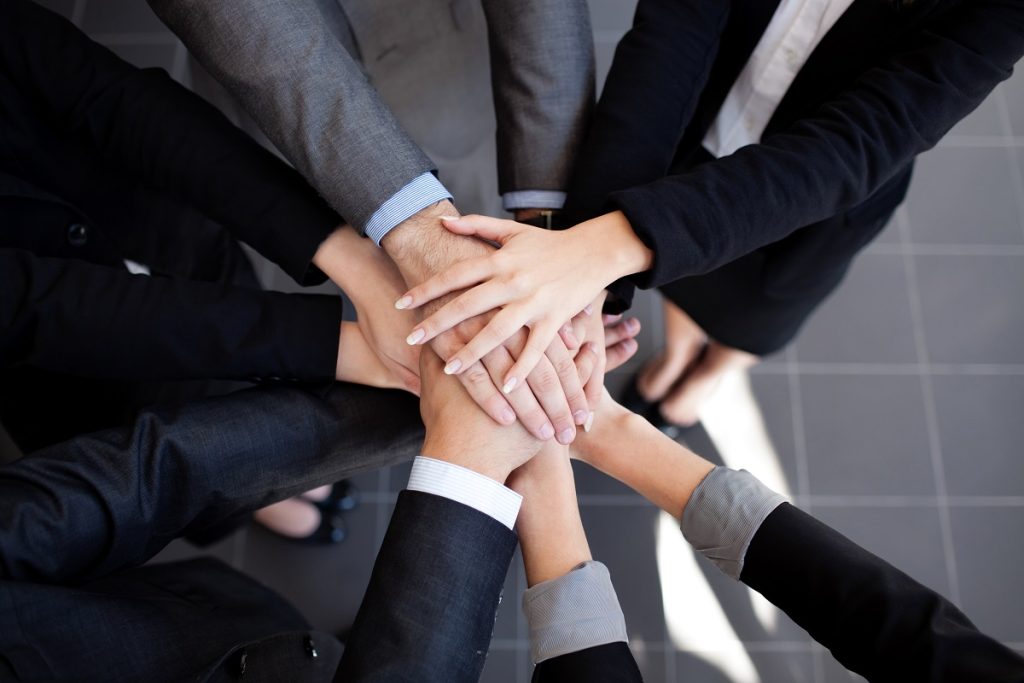 business people joining hands